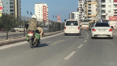 Mersin'de bir motosikletlinin akan trafikte koç taşıması dikkat çekti.