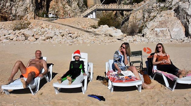 Kaş'ta turistler denize girdi, ağaçlar çiçek açtı